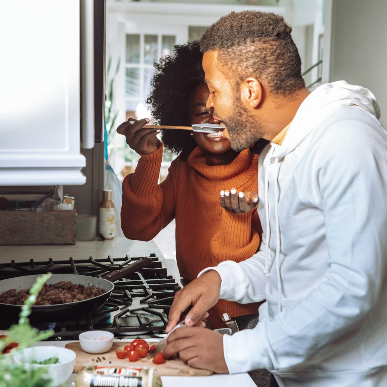 Community members collaborating in a modern kitchen space, sharing recipes and cooking techniques